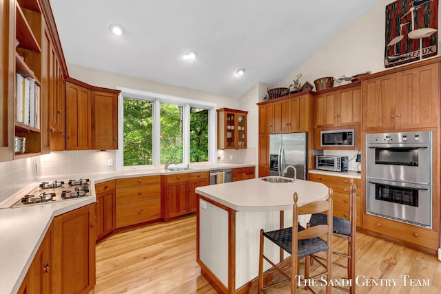 8985 Lakeshore Dr, West Olive, MI 49460 - kitchen with stainless steel appliances, a sink, vaulted ceiling, light wood finished floors, and recessed lighting