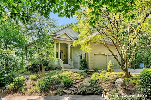 8985 Lakeshore Dr, West Olive, MI 49460 - view of front facade with an attached garage, driveway, and covered porch