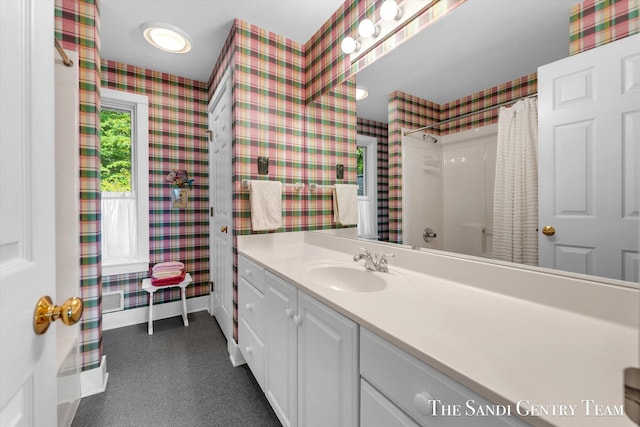 8985 Lakeshore Dr, West Olive, MI 49460 - full bath featuring wallpapered walls, vanity, baseboards, and curtained shower