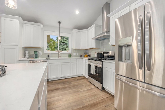 LotA Chandler Drive Ne, Belmont, MI 49306 - kitchen featuring appliances with stainless steel finishes, wall chimney exhaust hood, a sink, backsplash, and light wood-style flooring