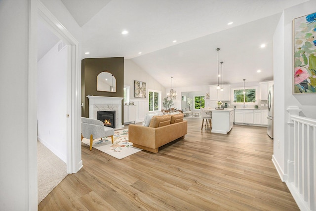 LotA Chandler Drive Ne, Belmont, MI 49306 - living area with a premium fireplace, light wood-style flooring, recessed lighting, a chandelier, and high vaulted ceiling