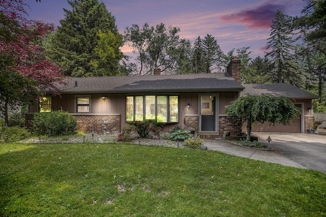 219 W Hamilton Ln, Battle Creek, MI 49015 - single story home featuring asphalt driveway, a chimney, a front yard, a garage, and brick siding