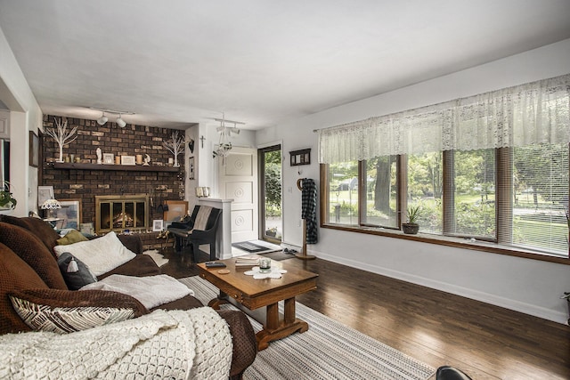 219 W Hamilton Ln, Battle Creek, MI 49015 - living area featuring wood finished floors, baseboards, and a fireplace