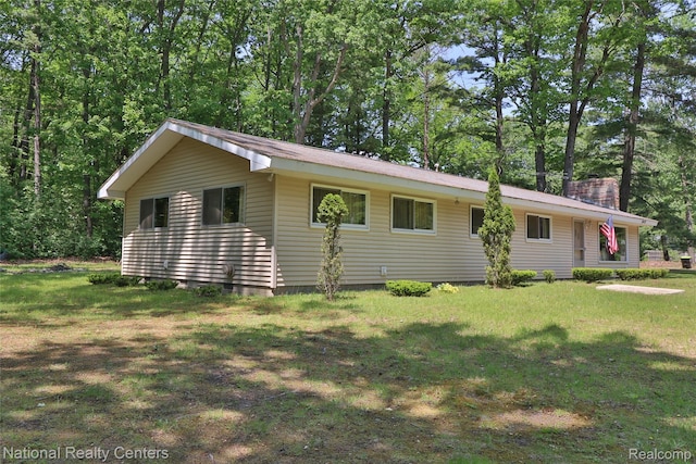 10475 W Higgins Lake Dr, Roscommon, MI 48653 - view of side of home with a chimney and a lawn