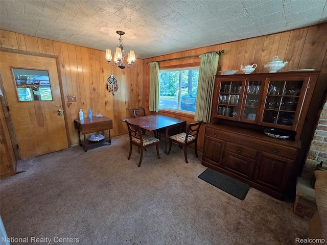 10475 W Higgins Lake Dr, Roscommon, MI 48653 - carpeted dining area with a chandelier and wooden walls
