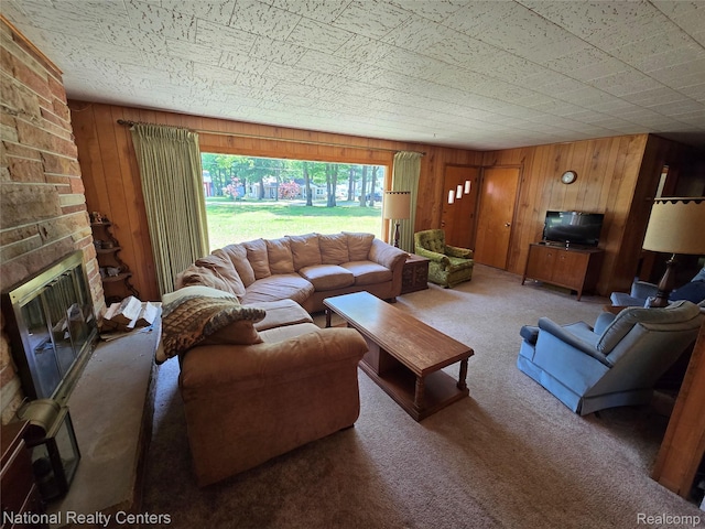 10475 W Higgins Lake Dr, Roscommon, MI 48653 - carpeted living area featuring wood walls and a fireplace
