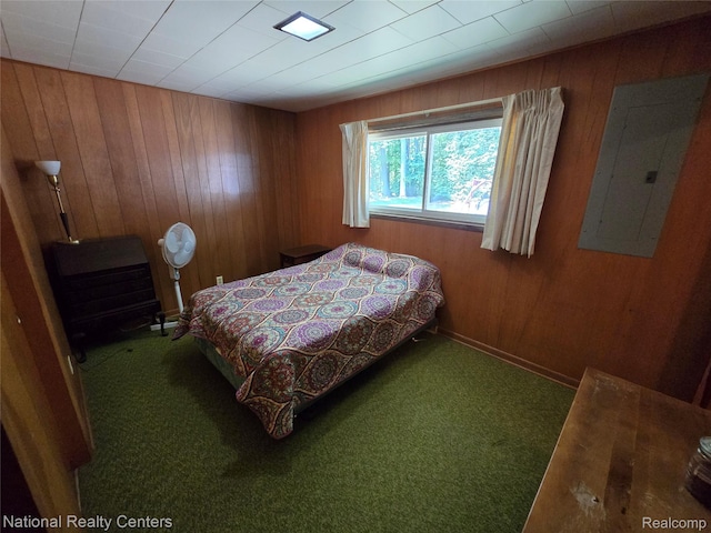 10475 W Higgins Lake Dr, Roscommon, MI 48653 - bedroom featuring wood walls, electric panel, and carpet