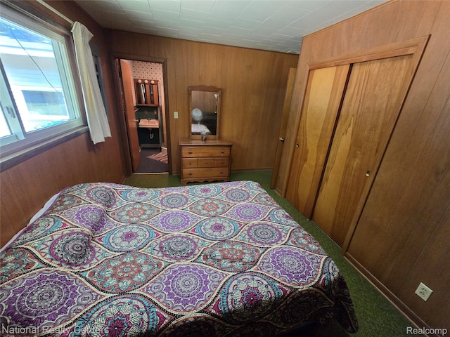 10475 W Higgins Lake Dr, Roscommon, MI 48653 - carpeted bedroom with wood walls and a closet