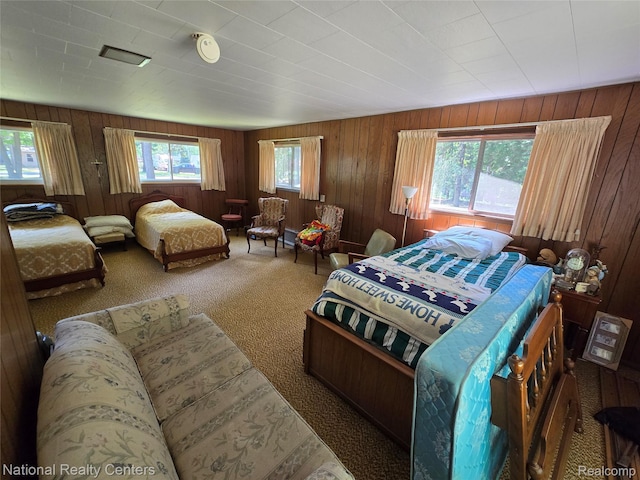 10475 W Higgins Lake Dr, Roscommon, MI 48653 - bedroom with carpet flooring and wooden walls