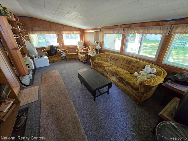 10475 W Higgins Lake Dr, Roscommon, MI 48653 - living room with lofted ceiling, carpet floors, and wood walls