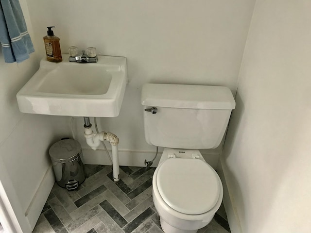 66223 Grey Lake Rd, Sturgis, MI 49091 - bathroom featuring toilet, a sink, and baseboards