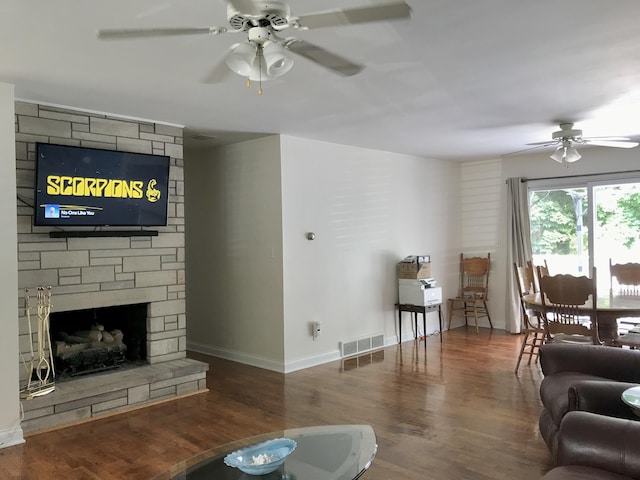 66223 Grey Lake Rd, Sturgis, MI 49091 - living area featuring a ceiling fan, wood finished floors, baseboards, and a stone fireplace