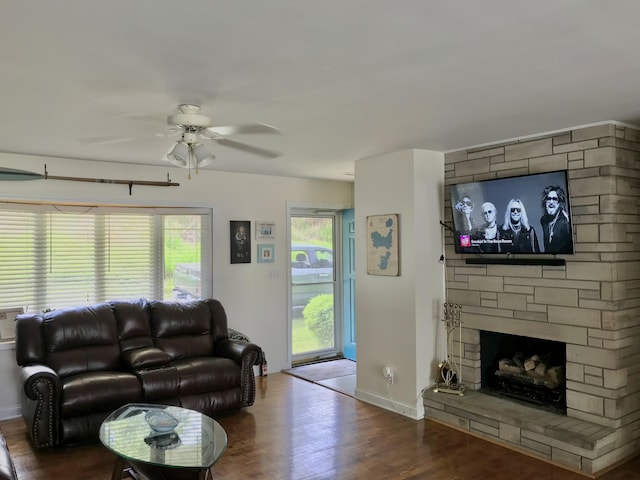 66223 Grey Lake Rd, Sturgis, MI 49091 - living area with a ceiling fan, wood finished floors, baseboards, and a stone fireplace