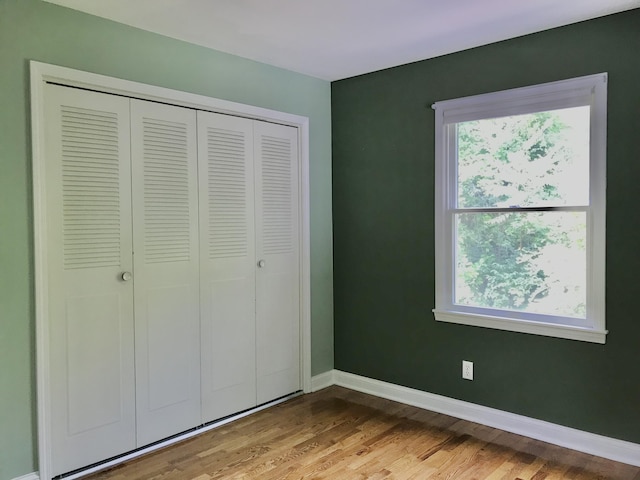 66223 Grey Lake Rd, Sturgis, MI 49091 - unfurnished bedroom featuring wood finished floors, baseboards, and a closet