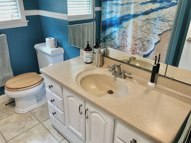 66223 Grey Lake Rd, Sturgis, MI 49091 - full bathroom featuring plenty of natural light, toilet, vanity, and wainscoting