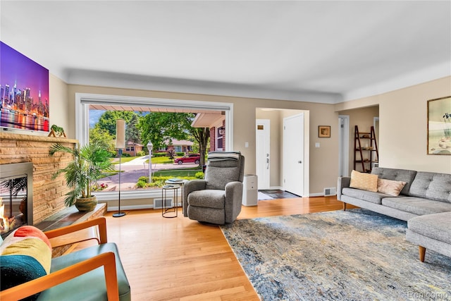 4006 Highfield Rd, Royal Oak, MI 48073 - living room featuring a glass covered fireplace, wood finished floors, and baseboards