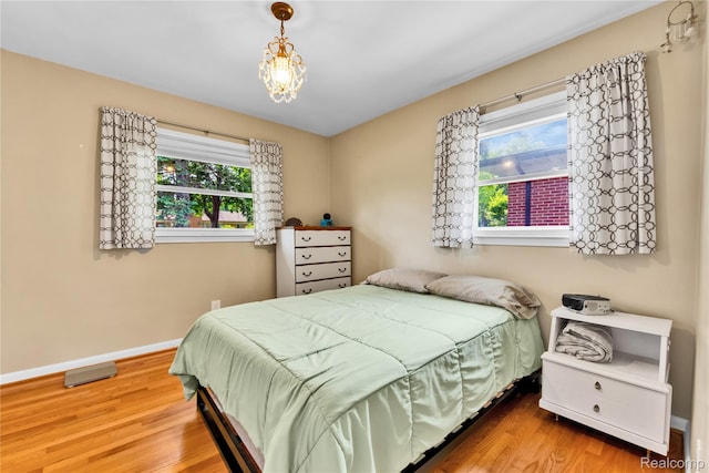 4006 Highfield Rd, Royal Oak, MI 48073 - bedroom with wood finished floors, multiple windows, and baseboards