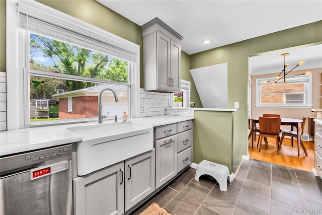 4006 Highfield Rd, Royal Oak, MI 48073 - kitchen featuring dishwasher, gray cabinets, a sink, a chandelier, and healthy amount of natural light