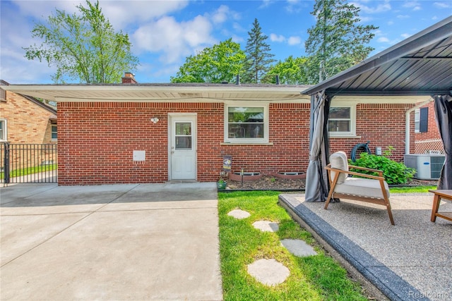 4006 Highfield Rd, Royal Oak, MI 48073 - view of front of property with cooling unit, brick siding, a chimney, and a patio area