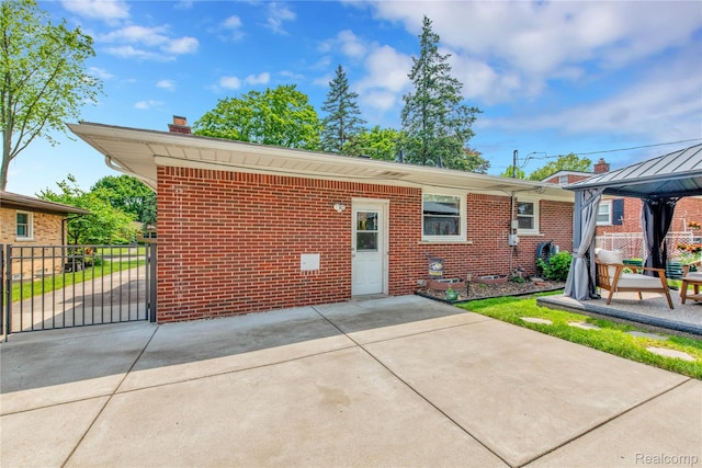 4006 Highfield Rd, Royal Oak, MI 48073 - view of front of property with brick siding, a gazebo, a chimney, a patio area, and concrete driveway