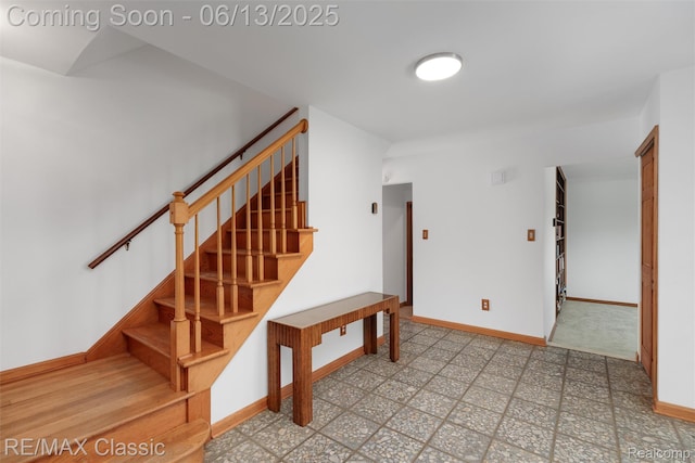 8173 Earhart Rd, South Lyon, MI 48178 - stairway with baseboards and tile patterned floors