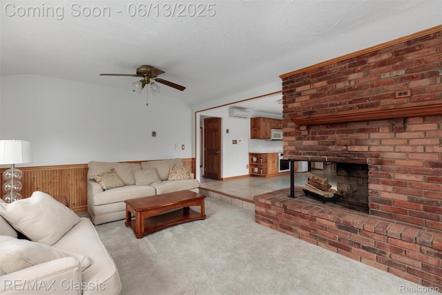 8173 Earhart Rd, South Lyon, MI 48178 - carpeted living room featuring a wall mounted AC, ceiling fan, a fireplace, wainscoting, and lofted ceiling