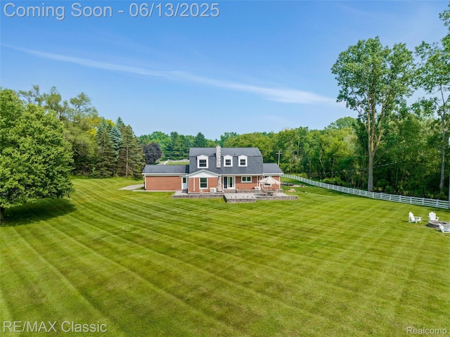 8173 Earhart Rd, South Lyon, MI 48178 - rear view of house with a forest view and a patio