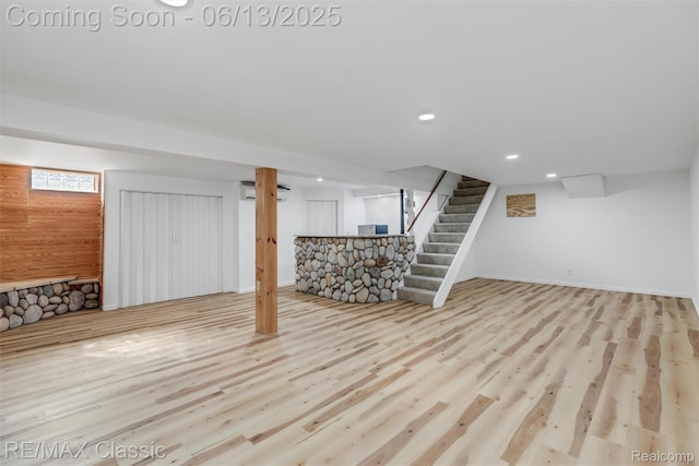 8173 Earhart Rd, South Lyon, MI 48178 - finished basement featuring stairway, recessed lighting, wood finished floors, baseboards, and an AC wall unit