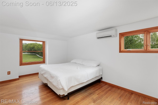 8173 Earhart Rd, South Lyon, MI 48178 - bedroom with an AC wall unit, multiple windows, and baseboards