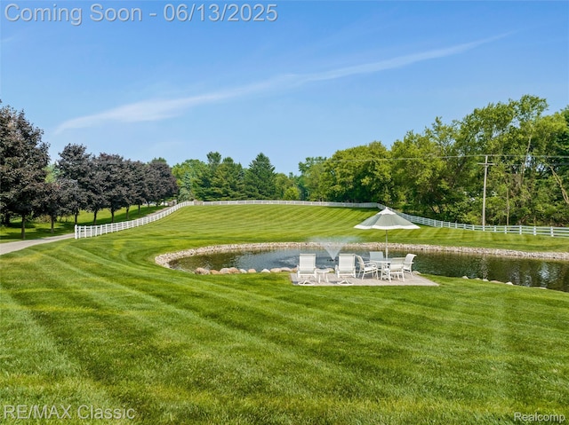 8173 Earhart Rd, South Lyon, MI 48178 - surrounding community with a water view, a patio area, and view of scattered trees