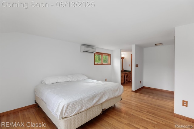 8173 Earhart Rd, South Lyon, MI 48178 - bedroom with a wall mounted AC, light wood-style floors, and baseboards