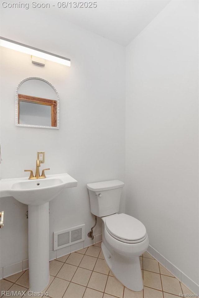 8173 Earhart Rd, South Lyon, MI 48178 - half bath featuring tile patterned floors, toilet, and baseboards