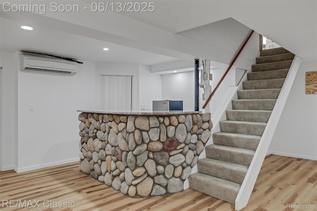 8173 Earhart Rd, South Lyon, MI 48178 - bar featuring a wall mounted air conditioner, wood finished floors, stairway, recessed lighting, and baseboards