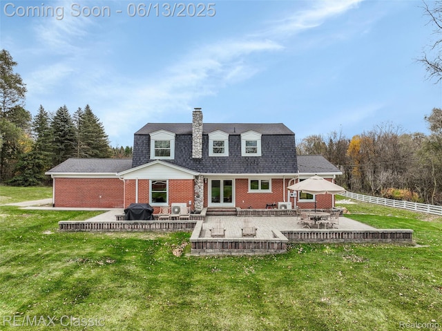 8173 Earhart Rd, South Lyon, MI 48178 - back of property with brick siding, a chimney, a patio area, and roof with shingles