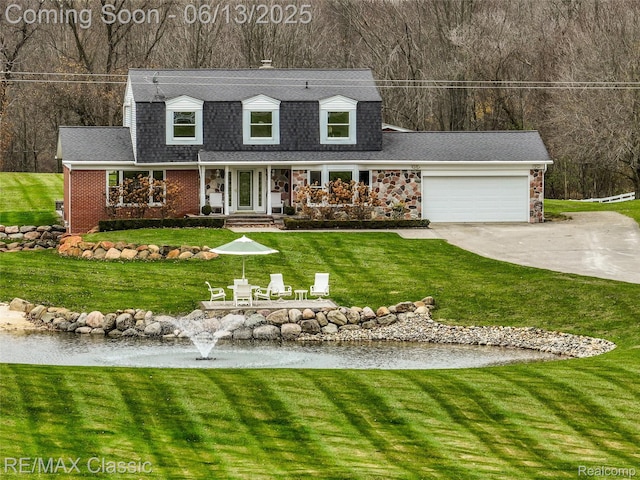 8173 Earhart Rd, South Lyon, MI 48178 - view of front of house featuring driveway, a garage, a front lawn, a shingled roof, and brick siding