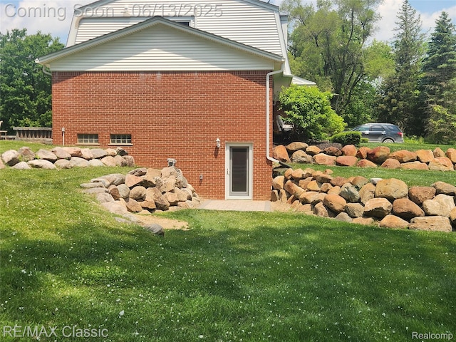 8173 Earhart Rd, South Lyon, MI 48178 - view of home's exterior featuring brick siding and a lawn