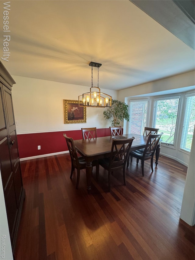 14232 Berryknoll Dr, Shelby Twp, MI 48315 - dining room featuring dark wood-style floors, baseboards, and a chandelier