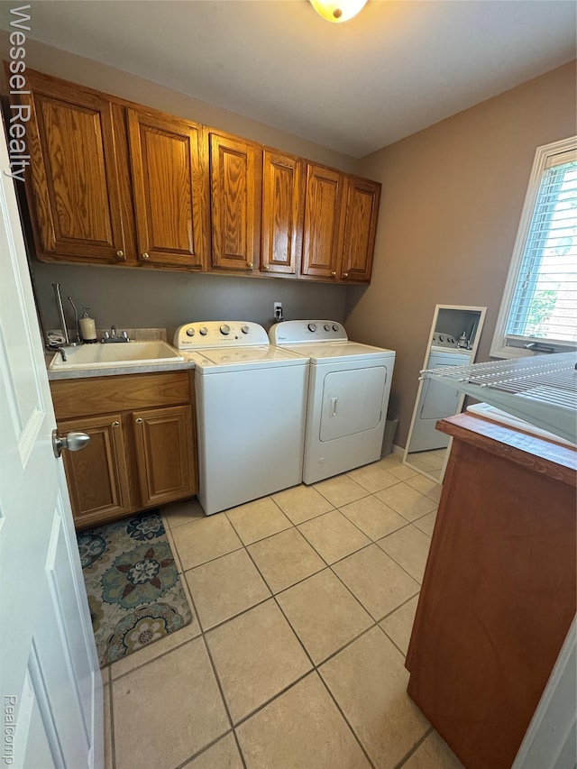 14232 Berryknoll Dr, Shelby Twp, MI 48315 - laundry area with cabinet space, washer and clothes dryer, and light tile patterned flooring