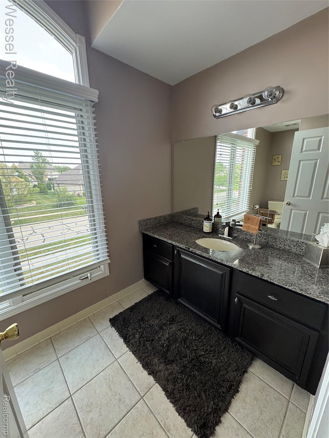 14232 Berryknoll Dr, Shelby Twp, MI 48315 - bathroom with tile patterned floors, vanity, plenty of natural light, and baseboards