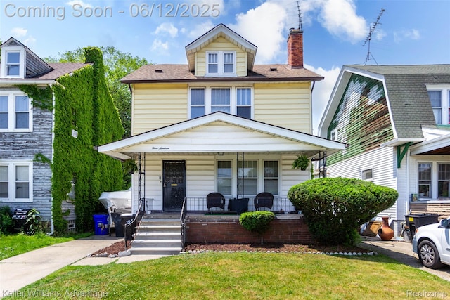 319 Marlborough St, Detroit, MI 48215 - american foursquare style home featuring a porch, a front yard, and a chimney
