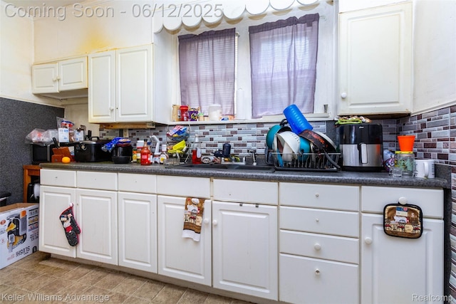 319 Marlborough St, Detroit, MI 48215 - kitchen with dark countertops, backsplash, white cabinetry, and a sink