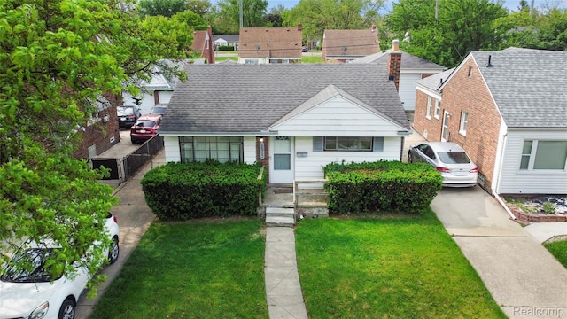 16752 Stricker Ave, Eastpointe, MI 48021 - view of front facade with a front lawn and roof with shingles