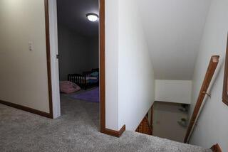 2924 Austin St, Muskegon, MI 49444 - staircase with carpet floors and lofted ceiling
