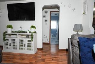 2924 Austin St, Muskegon, MI 49444 - living room with arched walkways, wood finished floors, and baseboards