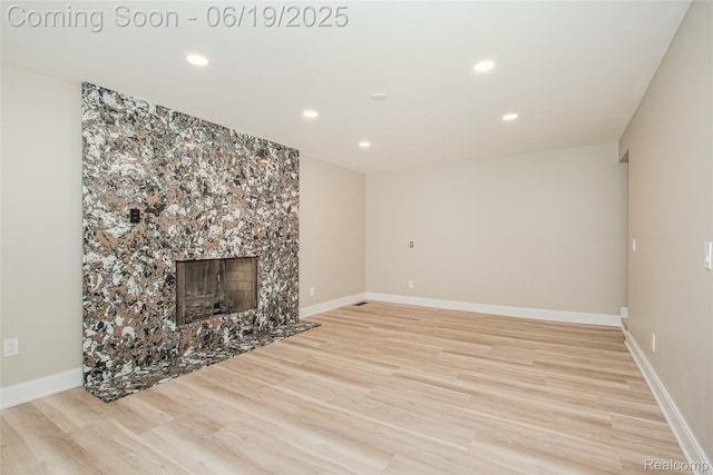 21993 Riverview Dr, Bloomfield Hills, MI 48025 - unfurnished living room featuring light wood-type flooring, recessed lighting, and a premium fireplace