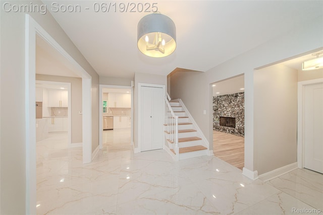 21993 Riverview Dr, Bloomfield Hills, MI 48025 - stairway with marble tiled flooring and a high end fireplace