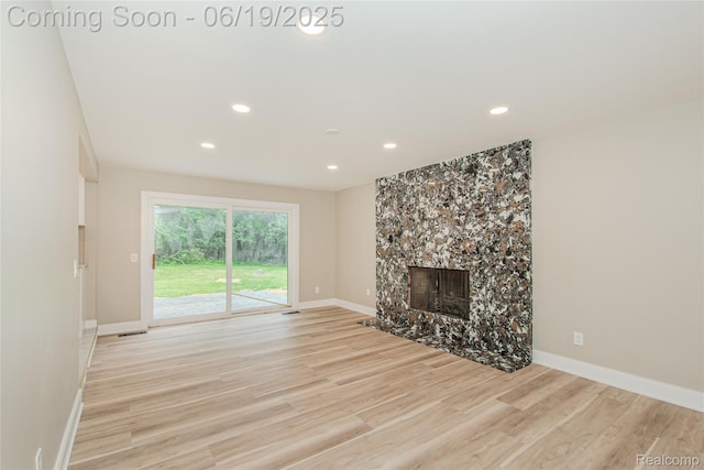 21993 Riverview Dr, Bloomfield Hills, MI 48025 - unfurnished living room with light wood-type flooring, recessed lighting, and a high end fireplace