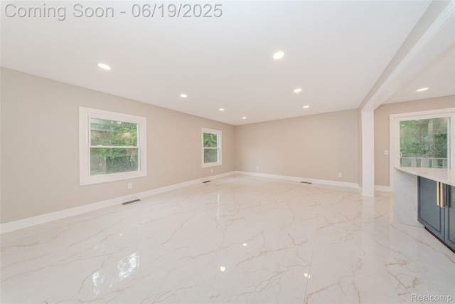 21993 Riverview Dr, Bloomfield Hills, MI 48025 - unfurnished room featuring light marble finish flooring, healthy amount of natural light, and recessed lighting