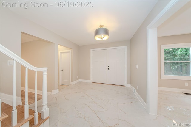21993 Riverview Dr, Bloomfield Hills, MI 48025 - foyer entrance featuring light marble finish floors and stairway