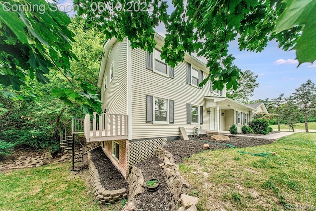 21993 Riverview Dr, Bloomfield Hills, MI 48025 - view of front of property with a front yard, a wooden deck, and stairs